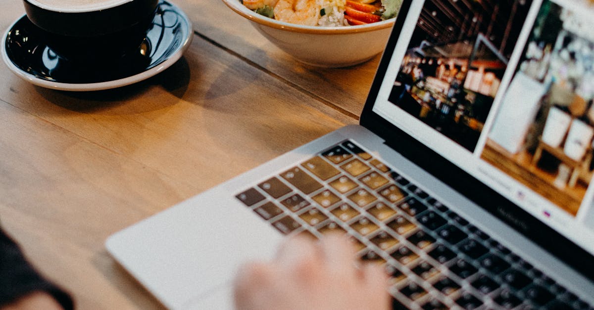 A contemporary workspace with a laptop, coffee, and a bowl of soup, ideal for remote work settings.